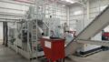 FAUDI Brikettierpresse mit rotem Container in Produktionshalle