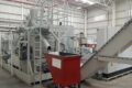 FAUDI briquetting press with red container in production hall