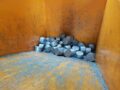 Briquettes in collecting container after pressing process through briquetting press