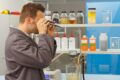 FAUDI inspection and test laboratory where a man looks through a microscope