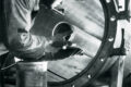 Black and white shot of a man installing separator elements in a water separator - FAUDI history