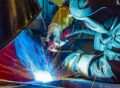 Man during welding work in the rolling mill and steel industry 